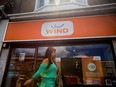 A woman walks by a Wind Mobile store in Toronto.