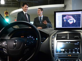 Blackberry QNX Director of Engineering Sheridan Ethier speaks to Prime Minister Justin Trudeau as he visits the Blackberry QNX facility in Ottawa