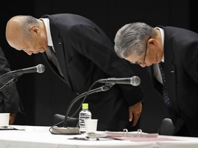 President and CEO of the top Japanese advertising company Dentsu Inc. Tadashi Ishii, left, bows with other senior executives during a press conference at the company's headquarters in Tokyo, Wednesday, Dec. 28, 2016.