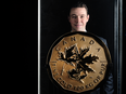 Abitibi Royalties CEO Ian Ball stands with an authentic $1 million dollar gold coin produced by the Royal Canadian Mint, in the Barrick Gold Corp. Gallery at Toronto's Royal Ontario Museum.