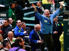 Traders work in the gold futures pit at the New York Mercantile Exchange.