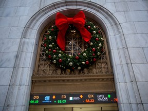 A Christmas wreath hangs above an entrance to the New York Stock Exchange in New York.