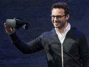 Brendan Iribe, co-founder and chief executive officer of Oculus VR Inc., displays the new Oculus Rift virtual reality (VR) headset while speaking during the Oculus VR Inc. "Step Into The Rift" event in San Francisco, California, U.S., on Thursday, June 11, 2015.