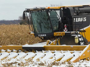 A combine sits dusted in snow north of London, Ont.