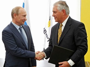Russian President Vladimir Putin, left, and ExxonMobil CEO Rex Tillerson shake hands at a signing ceremony of an agreement between state-controlled Russian oil company Rosneft and ExxonMobil at the Black Sea port of Tuapse, southern Russia on June 15, 2012.