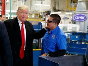 President-elect Donald Trump talks with workers during a visit to the Carrier factory