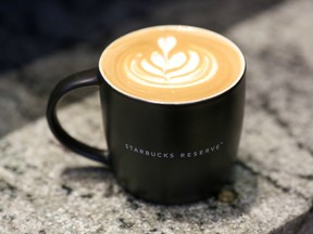 A cappuccino coffee sits in a Starbucks Corp. Reserve cup, used for specialist coffee, on the counter at a Starbucks coffee shop in London, U.K.
