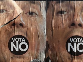 Anti-referendum posters showing Premier Matteo Renzi are seen in Rome a day after the referendum voteon Sunday. Italian voters dealt Premier Renzi a resounding rebuke early Monday by rejecting his proposed constitutional reforms, plunging Europe's fourth-largest economy into political and economic uncertainty.