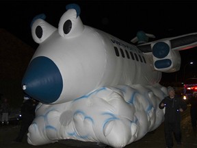 An inflatable WestJet plane rolls along as part of the annual Santa Claus Parade along Franklin Avenue in Fort McMurray Alta. on Saturday December 3, 2016.