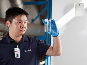 An Axine technician checks water quality in a lab.