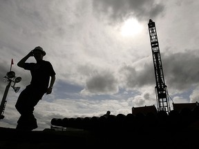 Workers from Northern Dynasty Minerals drill core samples.