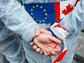 An activist demonstrates in front of French Agriculture ministry to protest against the EU trade deal with Canada, known as CETA.