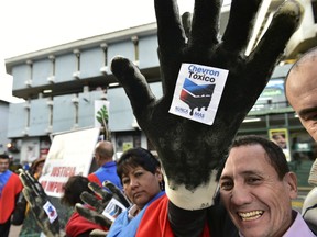 Activists protest against US multinational energy corporation Chevron at a square in Quito on May 21, 2014.