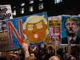 Demonstrators hold up placards during a protest outside Downing Street against U.S. President Donald Trump's ban on travel from seven Muslim countries on Monday in London.
