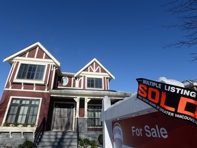 A real estate sold sign is shown outside a house in Vancouver, Tuesday, Jan.3, 2017.