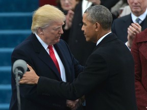 US President Barack Obama (R) greets President-elect Donald Trump as he arrives on the platform at the US Capitol in Washington, DC, on January 20, 2017, before his swearing-in ceremony.