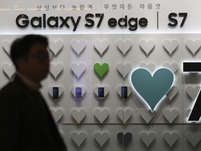 A man walks by an advertisement of the Samsung Electronics Galaxy S7 Edge and S7 smartphones in Seoul, South Korea, Friday, Jan. 6, 2017. Samsung Electronics Co. said Friday that its profits in the last quarter of 2016 surged 50 percent to the highest level in more than three years, despite the Galaxy Note 7 fiasco. (AP Photo/Lee Jin-man)