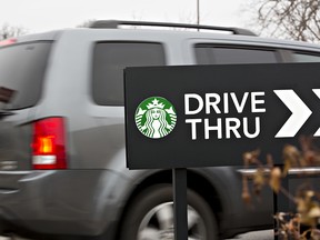 A logo is displayed on a drive thru sign outside a Starbucks Corp. coffee shop in Peoria, Illinois, U.S., on Wednesday, Jan. 25, 2017.