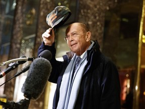 Wilbur Ross talks with reporters in the lobby of Trump Tower.
