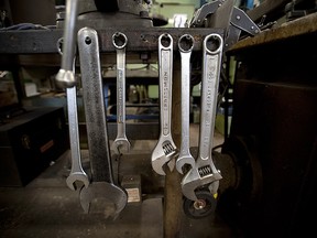 Sears Brand LLC Craftsman hand tools hang on the end of a work bench