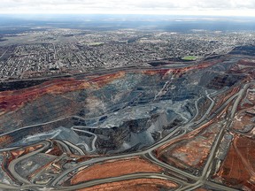 The township of Kalgoorlie stands next to the Fimiston Open Pit mine, known as the Super Pit, in this aerial photograph taken above Kalgoorlie, Australia, on Monday, Aug. 3, 2015.