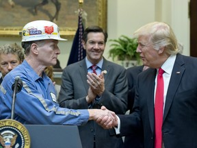 A coal miner identified as Kevin shakes hands with U.S. President Donald Trump prior to the President signing H.J. Res. 38, disapproving the rule submitted by the US Department of the Interior known as the Stream Protection Rule in the Roosevelt Room of the White House on February 16, 2017 in Washington, DC.