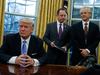 National Trade Council adviser Peter Navarro, right, and White House Chief of Staff Reince Priebus, center, with  Donald Trump in the oval office on Trump’s first business day as U.S. president.
