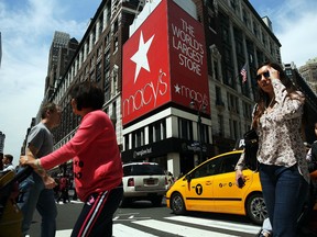 Pedestrians walk by Macy's flagship store in Herald Square on May 11, 2016 in New York, New York.