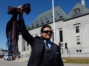 Gabriel Daniels, son of the late Harry Daniels, reacts as he leaves the Supreme Court of Canada in Ottawa on Thursday, April 14, 2016, following their unanimously ruling that Metis and non-status are Indians under the Constitution. The Congress of Aboriginal Peoples joined with several individuals, including Metis leader Harry Daniels, in taking the federal government to court in 1999 to allege discrimination because they were not considered "Indians" under the Constitution.