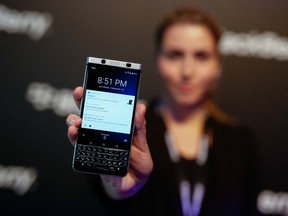 An attendee holds the Blackberry KEYone smartphone, during its launch event