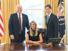 A photo posted to twitter showing President Donald Trump, Ivanka Trump sitting in the President's chair and Prime Minister Justin Trudeau.