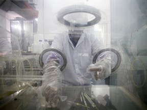 A research assistant prepares syringes inside a pharmacy glovebox at the RISUG R&D laboratory at the Indian Institute of Technology.