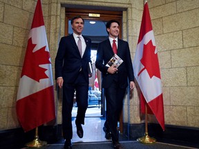 Finance Minister Bill Morneau and Prime Minister Justin Trudeau hold copies of the 2017 budget.