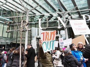 Protesters demonstrate in front of the Trump International Hotel and Tower in Vancouver during the hotel's opening day on February 28, 2017.