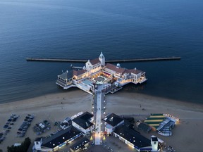 A recreational facility overlooking the sea is illuminated at dusk at a beach in Fukuoka, Japan.