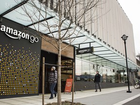 Pedestrians walk past the new Amazon.com Inc. Go grocery store in Seattle, Washington, U.S., on Wednesday, March 8, 2017.