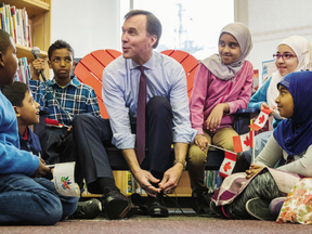 Canada's federal Finance Minister Bill Morneau takes part in the pre-budget ceremony of putting on new shoes at the Nelson Mandela Park Public School in Toronto