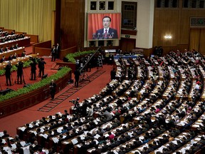 In this March 5, 2016 file photo, Chinese Premier Li Keqiang appears on a big screen as he delivers a work report at the opening session of the annual National People's Congress at the Great Hall of the People in Beijing.