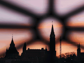 Buildings stand at sunrise on Parliament Hill in Ottawa.