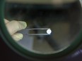 An employee uses a magnifying lens and tweezers to inspect a Torasemid AL high blood pressure tablet at the Stada Arzneimittel AG pharmaceutical factory in Bad Vilbel, Germany, on Wednesday, April 9, 2014.