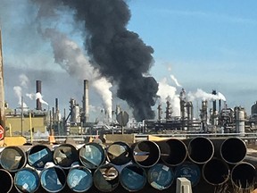 A plume of smoke hangs over the Syncrude Canada Ltd. Mildred Lake Upgrader near Fort McMurray on Tuesday, March 14, 2017