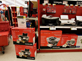 Discounted Lexmark office equipment is shown on display at a Staples store