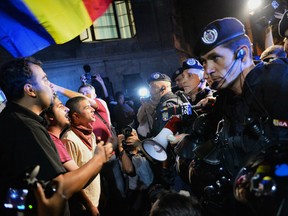 Protesters argue with gendarmes  during the fourth day of demonstrations in Bucharest against the Rosia Montana Gold Corporation (RMGC), a Canadian gold mine project using cyanide, September 4, 2013. Canadian company Gabriel Resources hopes to extract 300 tons of gold using thousands of tons of cyanide in Rosia Montana, a picturesque village in the Carpathian mountains.