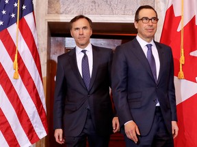Treasury Secretary Steven Mnuchin, right, walks with Canadian Finance Minister Bill Morneau before their bilateral meeting at the Treasury Department in Washington on Wednesday.