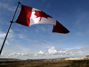 A Canadian flag waves over Alberta’s oilsands.