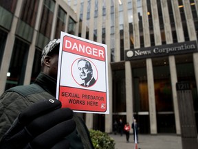 A protester holds a sign in front of 21st Century Fox offices in New York last Wednesday, the day Bill O'Reilly was fired.