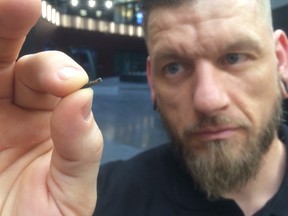 Self-described “body hacker” Jowan Osterlund from Biohax Sweden, holds a small microchip implant, similar to those implanted into workers at the Epicenter digital innovation business centre.