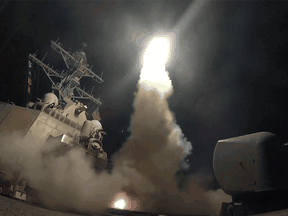 n this image provided by the U.S. Navy, the guided-missile destroyer USS Porter  launches a tomahawk land attack missile in the Mediterranean Sea, Friday, April 7.