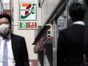 The Seven & I Holdings Co. logo is displayed outside a 7-eleven convenience store, operated by Seven & i Holdings Co., in Tokyo, Japan, on Thursday, April 6, 2017.