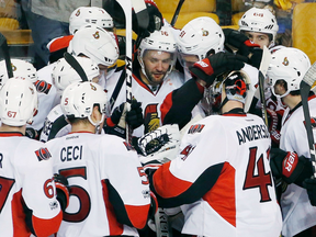 Ottawa Senators celebrate after scoring during overtime in game six of a first-round NHL hockey Stanley Cup playoff series against the Boston Bruins.